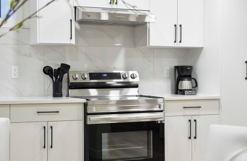 Southeast Edmonton Apartment | Modern & Elegant Executive Suite near Refinery Row. Office Desk + Kitchen